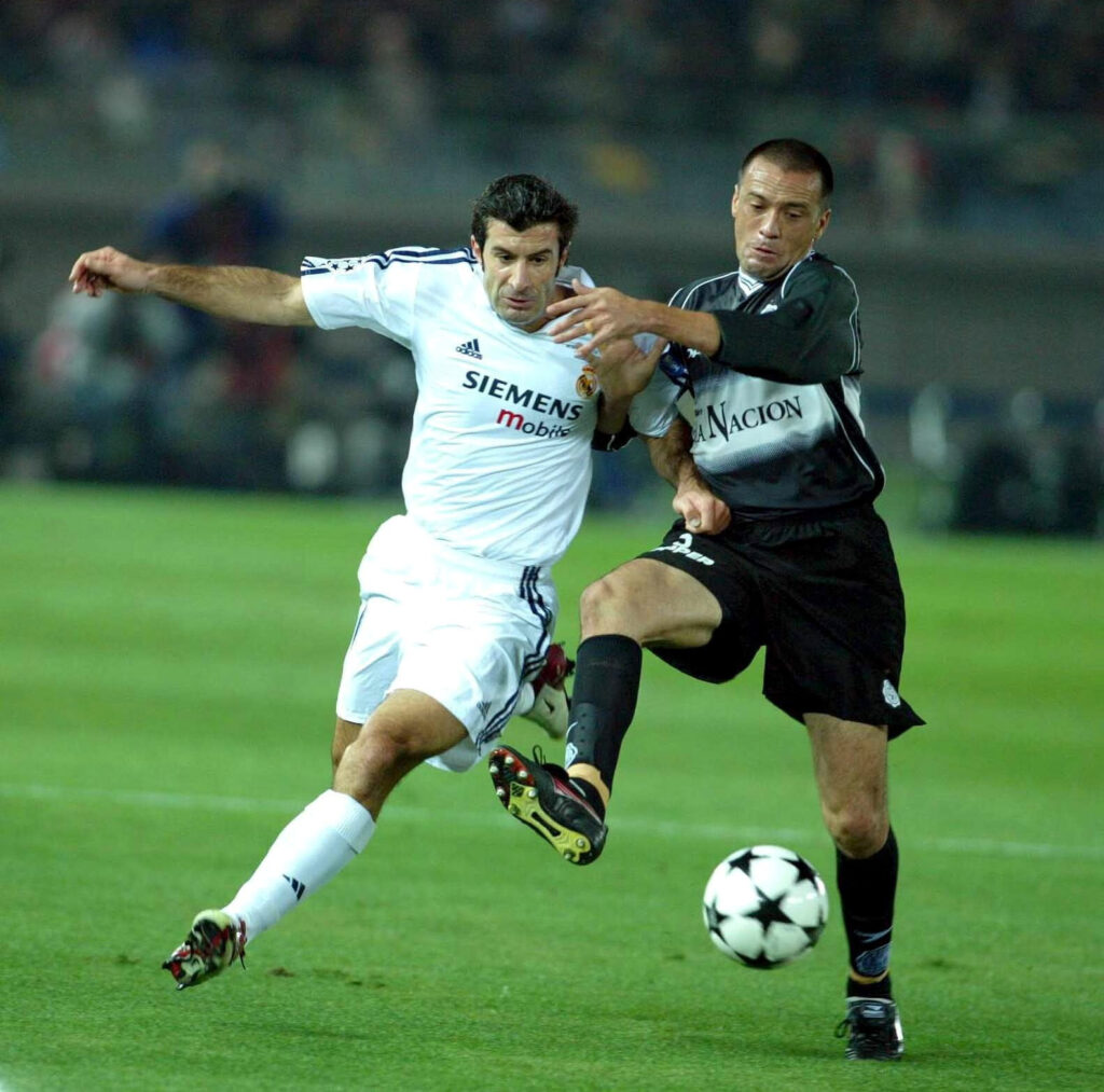 Luis Figo pelea por la pelota con un jugador del Olimpia en la Copa Intercontinental 2002.