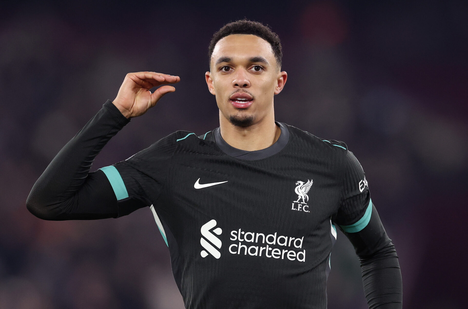 Trent Alexander-Arnold celebra su gol contra el West Ham realizando un gesto con la mano.