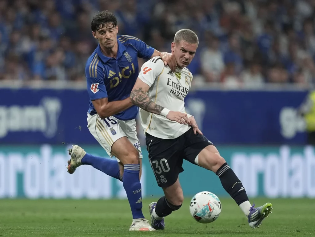Mastantuono lucha con un jugador del Real Oviedo por el balón.
