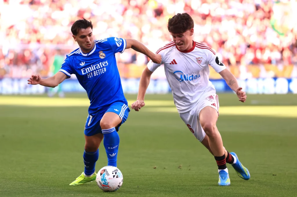 Brahim Díaz pelea por la pelota con un jugador del Sevilla en la victoria del Real Madrid en el Ramón Sánchez-Pizjuán.