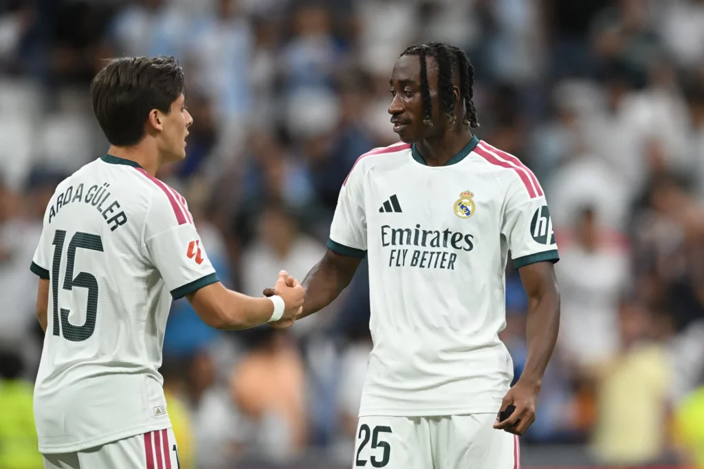 Diomande y Arda Güler se saludan durante un partido del Real Madrid.